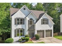 Charming two-story home featuring a two-car garage, beautiful landscaping, and elegant exterior details at 1097 Soaring Way, Marietta, GA 30062
