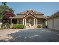 Charming home with a welcoming front porch, complemented by a spacious driveway and attached three-car garage at 105 Whippoorwill Way, Fayetteville, GA 30215
