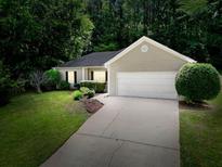 Charming single-story home with a well-manicured lawn and an attached two-car garage at 5600 Walnut Creek Nw Ct, Lilburn, GA 30047