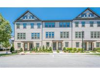 Charming townhome featuring a three-story layout, landscaped front yard and neutral color palette at 3693 Allegretto Cir, Atlanta, GA 30339