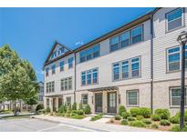 Charming townhome featuring a blend of brick and siding, complemented by neatly manicured landscaping at 3693 Allegretto Cir, Atlanta, GA 30339