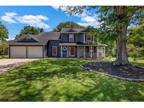 Charming two-story home featuring a well-manicured front yard and a cozy front porch at 2505 Tiffany Se Ct, Conyers, GA 30013