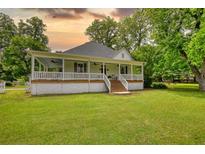 Charming one-story home with a welcoming porch and large front lawn at 123 Nelson Street, Newborn, GA 30056
