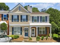 Charming townhouse featuring a well-maintained facade, complemented by neat landscaping and a cozy covered entrance at 216 Buckland Dr, Alpharetta, GA 30022