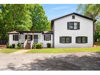 Charming two-story home with white siding, black trim, and inviting front porch at 3142 Chamblee Gap Rd, Cumming, GA 30040