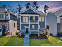 Charming two-story home featuring a double porch, stone accents, and well-manicured lawn at 5293 Hearthstone St, Stone Mountain, GA 30083
