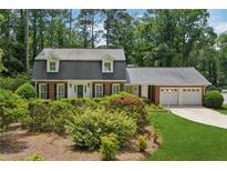 Charming two-story home with black shutters, a two-car garage, and beautifully landscaped front yard at 626 Cheatham Sw Dr, Marietta, GA 30064