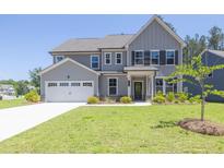 Charming two-story home with a well-manicured lawn and a two-car garage at 8 Foothills Trl, Sharpsburg, GA 30277