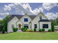 Charming two-story home with a well-manicured lawn and beautiful landscaping at 270 Alcovy Reserve Way, Covington, GA 30014