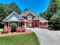 Charming brick home with well-manicured lawn and curved driveway at 781 Templeton Dr, Loganville, GA 30052