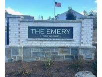 Starlight Homes community, The Emery, featuring a brick sign and an American flag at 305 Winston Way, Villa Rica, GA 30180