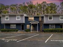 Two-story condo building with reserved parking spaces and a combination brick and siding facade at 3149 Buford Hwy # 3, Brookhaven, GA 30329