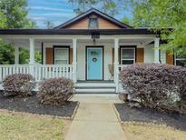 Charming home with a welcoming front porch, light blue door, and well-manicured landscaping at 377 Wyndham Way, Atlanta, GA 30315