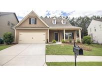Charming single-Gathering home featuring a two-car garage and manicured front yard landscaping at 610 Sunflower Dr, Canton, GA 30114