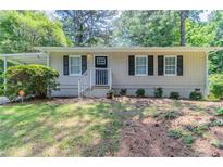 Charming single-story home with neutral siding, black shutters, and a welcoming front porch at 881 Mercury Nw Dr, Atlanta, GA 30331