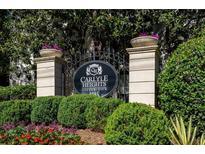 Elegant Carlyle Heights Condominium sign with beautiful landscaping and purple flowers at 1445 Monroe Ne Dr # C13, Atlanta, GA 30324