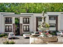 Modern condo building with a fountain and lush landscaping in a convenient location at 1445 Monroe Ne Dr # C13, Atlanta, GA 30324
