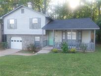 Charming two-story home with a stone facade, covered porch, and well-maintained front lawn at 2125 Jessica Way, Lithonia, GA 30058