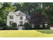 Charming two-story home features lush landscaping, a well-manicured lawn, and a stylish front entrance at 3390 River Ferry Dr, Alpharetta, GA 30022