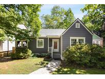 Charming bungalow-style house with gray siding, white trim, and a well-maintained front yard with mature trees and walkway at 1367 Ormewood Se Ave, Atlanta, GA 30316