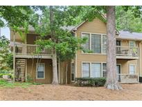 Inviting two-story townhome with cozy balconies nestled among mature trees and landscaped grounds at 2304 Country Park Se Dr, Smyrna, GA 30080