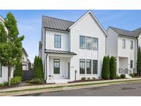 Charming two-story home with white brick exterior and black window trim at 6815 Halcyon Way, Alpharetta, GA 30005