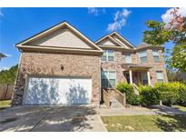 Charming two-story brick home featuring an attached garage and landscaped front yard at 1417 Sterlingbrooke Dr, Powder Springs, GA 30127
