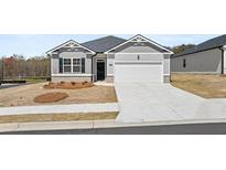 Charming single-story home featuring gray siding, a two-car garage, and a well-manicured front yard at 1624 Palladian Way, Lithonia, GA 30058
