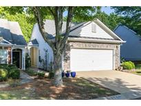 Charming single-Gathering home with stone accents, neutral siding, and a well-maintained two-car garage and driveway at 1640 Donovans Nw Rdg, Kennesaw, GA 30152