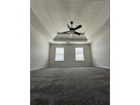 Spacious bedroom with neutral walls, tray ceiling with fan and wall to wall carpeting at 2837 Lakewater Way, Snellville, GA 30039
