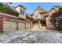 Stunning two-story home featuring a brick and stone exterior with a three-car garage at 3333 N Hembree Rd, Marietta, GA 30062