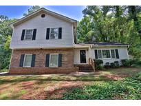 Charming two-story home featuring a brick facade and light gray siding at 752 Roxboro Trce, Lawrenceville, GA 30044