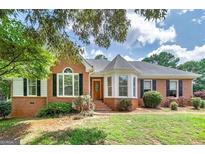 Charming brick home with a well-maintained lawn and lovely landscaping at 98 Country Acres Ct, Mcdonough, GA 30253