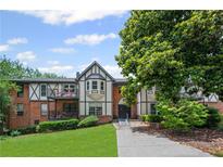 Charming condo exterior showcasing brick facade, multiple balconies and inviting front yard at 6851 Roswell Rd # E4, Atlanta, GA 30328