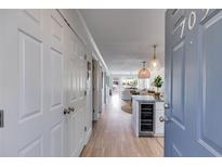 Inviting entryway with a wine fridge transitions to an open-concept living space with hardwood floors and lots of natural light at 705 Berry Ct, Villa Rica, GA 30180