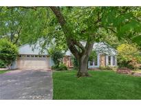 Charming home featuring a two-car garage, stone accents and mature tree in the front yard at 3299 Pete Shaw Rd, Marietta, GA 30066