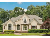 Charming two-story home with manicured landscaping, stone accents and a balcony overlooking the front yard at 5105 Deerlake Dr, Alpharetta, GA 30005