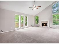 Bright living room with large windows, vaulted ceiling, carpet, and fireplace at 3006 Alberta Dr, Marietta, GA 30062
