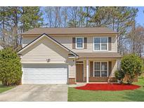 Charming two-story home with a well-maintained lawn and attached two-car garage at 145 Silver Mine Trl, Austell, GA 30168