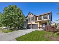 Charming two-story home with a two-car garage and well-manicured lawn under a clear blue sky at 4238 Sir Dixon Dr, Fairburn, GA 30213
