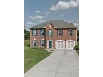 Charming brick two-story home with a two-car garage and long driveway, complemented by a well-manicured lawn at 9066 Bob Jackson Dr, Jonesboro, GA 30238