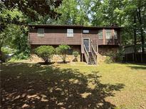 Charming two-story home with a stone facade and a cozy front yard with mature trees at 2685 Hyde Cir, Duluth, GA 30096