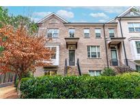 Beautiful brick townhome with manicured landscaping and inviting front entrance at 3786 Alstead Manor Way, Suwanee, GA 30024