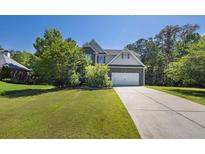 Charming two-story home with a well-manicured lawn and an inviting facade at 6645 Crest Wood Ln, Douglasville, GA 30135