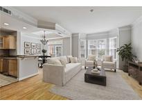 Bright living room features hardwood floors, bay window, open to kitchen and dining area, creating an inviting space at 850 Piedmont Ne Ave # 3304, Atlanta, GA 30308
