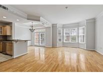 Bright living room featuring hardwood floors, a chandelier, and multiple windows at 850 Piedmont Ne Ave # 3304, Atlanta, GA 30308