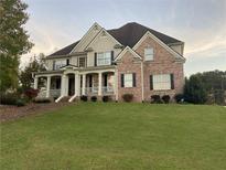 Charming two-story brick home with a manicured lawn and welcoming front porch at 388 Golf Crest Dr, Acworth, GA 30101