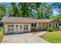 Charming brick home featuring large windows and a covered front porch at 15 Porter Cir, Hampton, GA 30228
