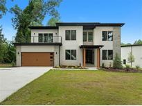 Modern home showcasing clean lines, a balcony, and a two-car garage at 1604 Niskey Lake Rd, Atlanta, GA 30331