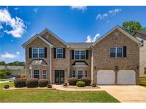 Beautiful two-story brick home with a two-car garage, manicured lawn and classic curb appeal at 2689 Muskeg Sw Ct, Atlanta, GA 30331